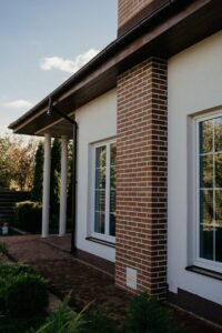 Charming modern house with brick features, glass windows, and lush garden.